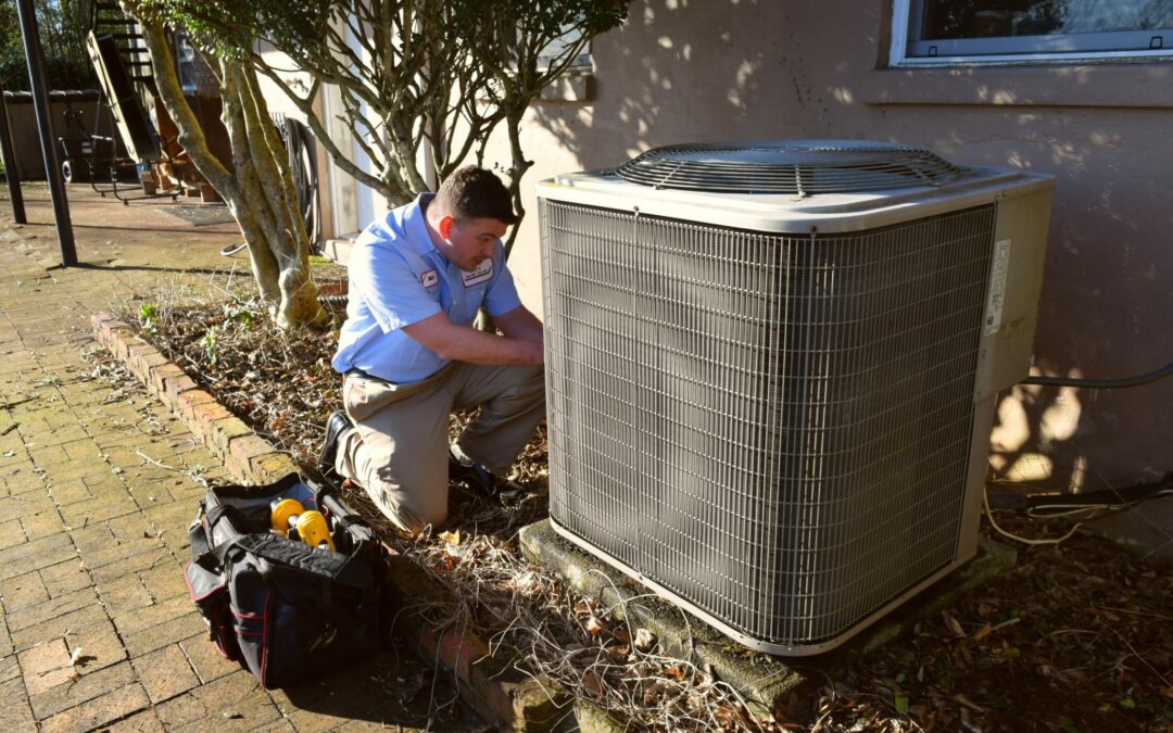 city heating and air conditioning in Knoxville, TN working on an HVAC outside home