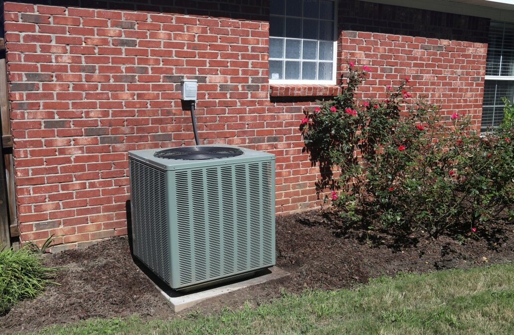 Air conditioner compressor condenser unit outside a brick home, used to cool the house. Works well when maintained with routine maintenance by a A/C technician