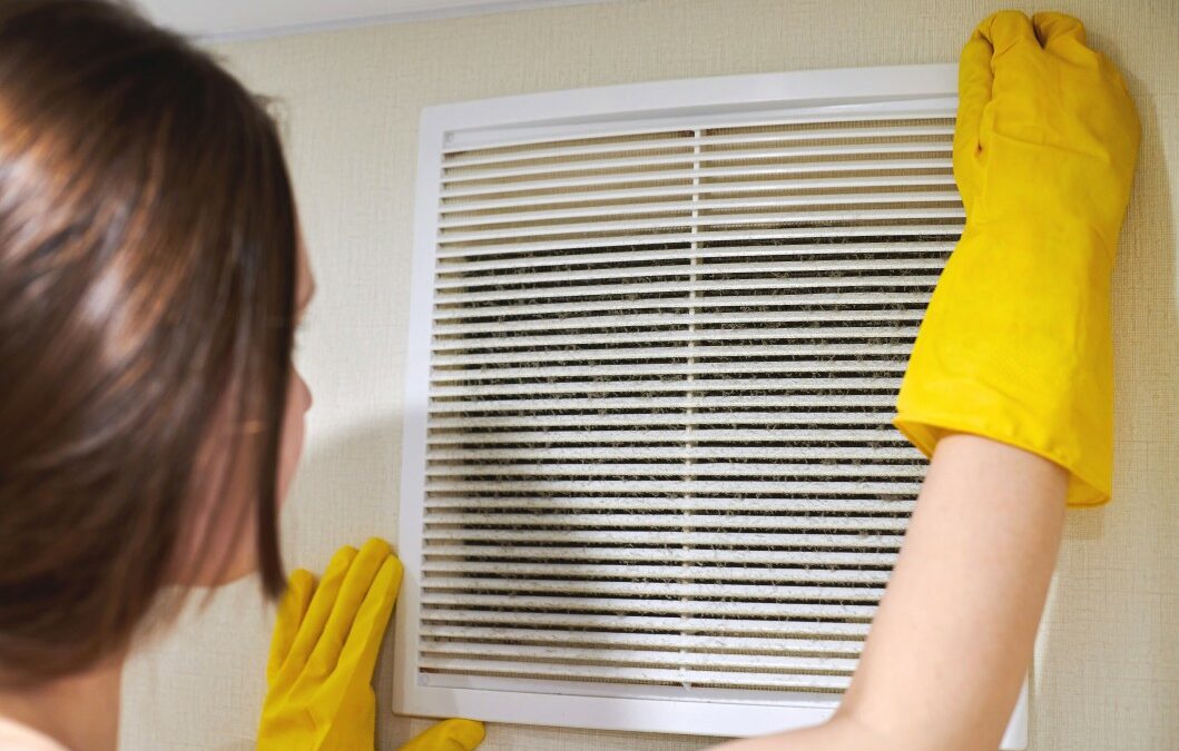 woman examining her air filter
